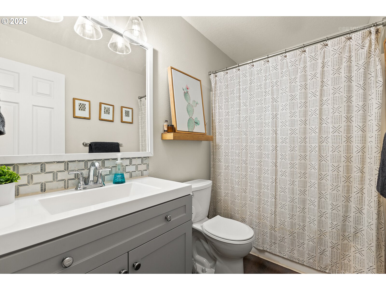 20102 Southwest 54th Terrace Tualatin, OR 97062 - Photo 22 of 35 a bathroom with a sink a toilet and a mirror