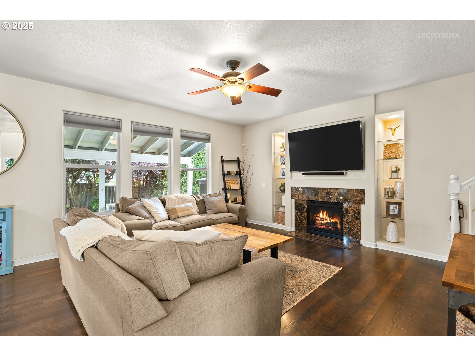 20102 Southwest 54th Terrace Tualatin, OR 97062 - Photo 5 of 35 a living room with furniture a fireplace and a flat screen tv