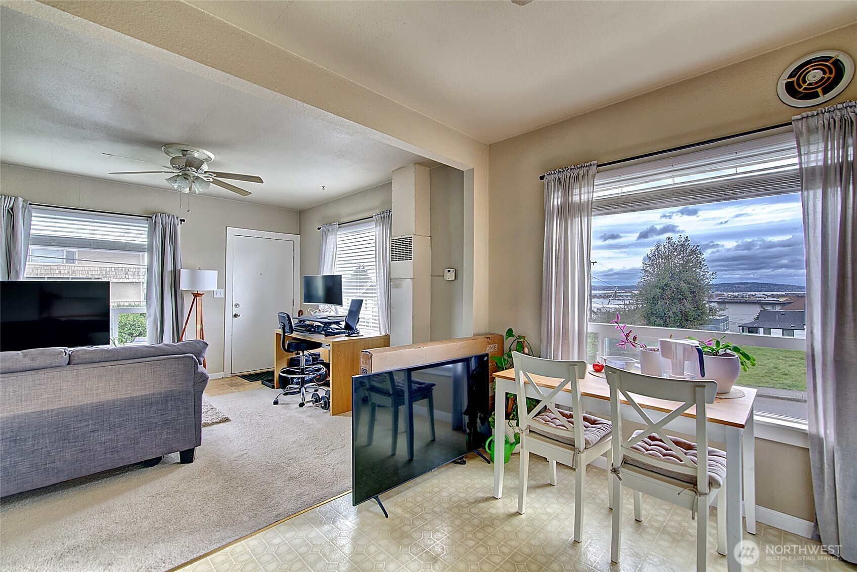 1018 Wall Street Everett, WA 98201 - Photo 8 of 20 a living room with furniture a flat screen tv and a large window