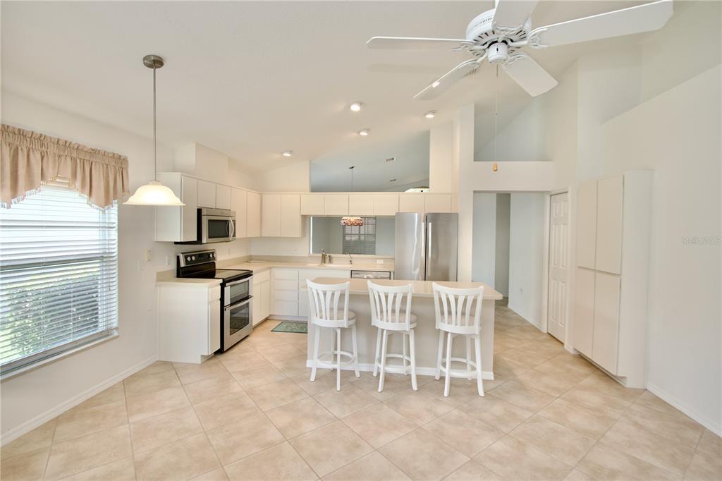 7842 Tenby Court New Port Richey, FL 34655 - Photo 11 of 27 a view of a dining room with furniture window and wooden floor