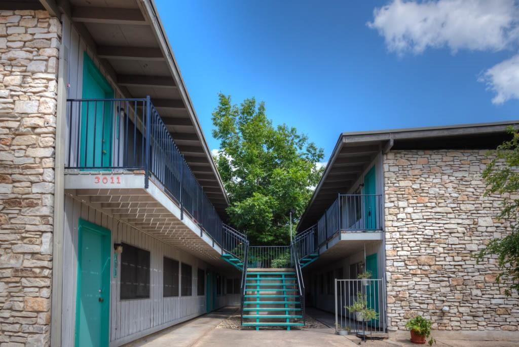 3011 Whitis Avenue, Unit 101 Austin, TX 78705 - Photo 6 of 7 View of property exterior with stone siding, stairway, and a balcony