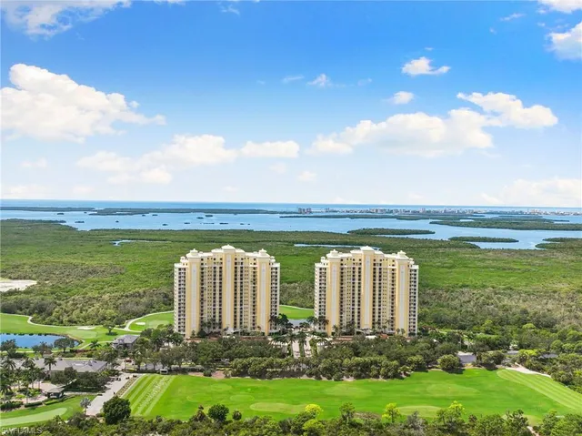 a view of a house with a big yard and large trees