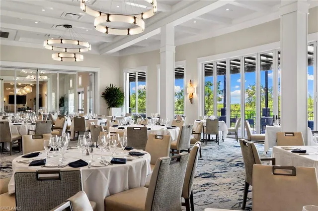 a view of a dining room with furniture large windows and wooden floor