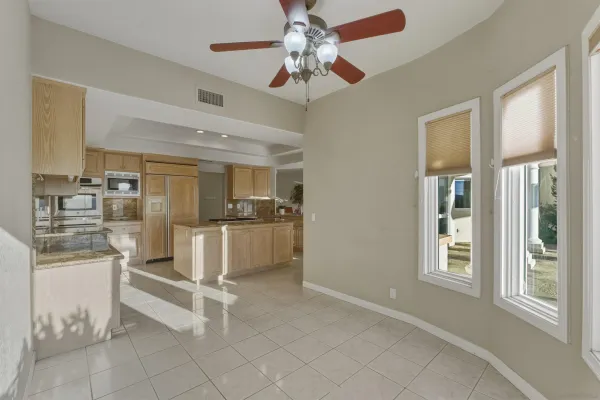 a kitchen with white cabinets and sink