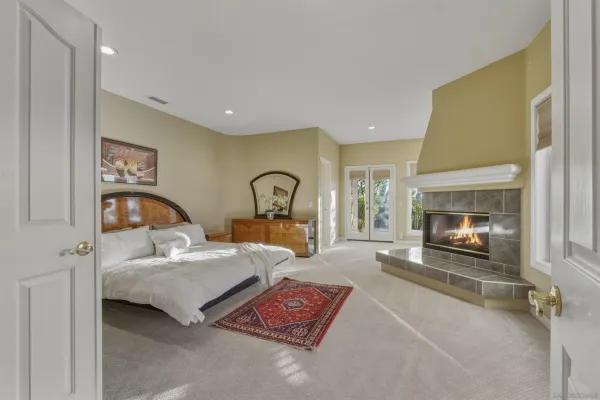 a spacious bedroom with a bed and a fireplace