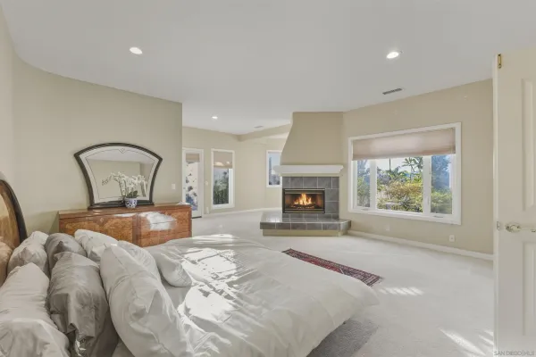 a bedroom with a bed and a fireplace