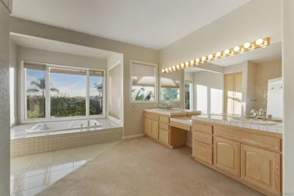 a large white kitchen with a large window