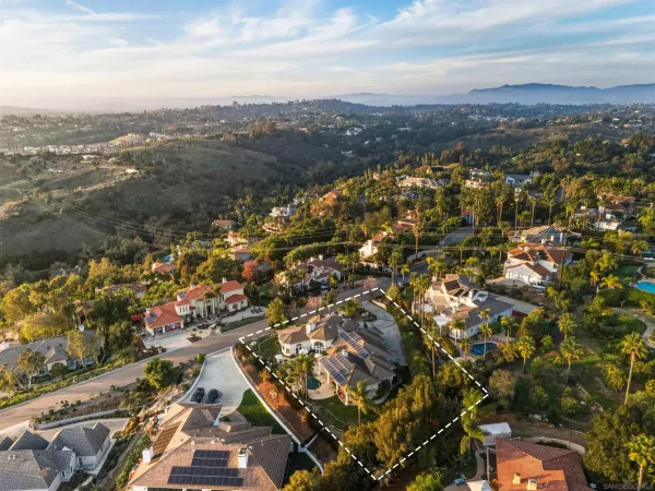 an aerial view of residential houses with city view