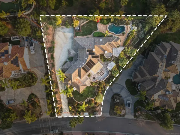 an aerial view of a house with a yard and potted plants