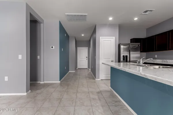 a view of kitchen with stainless steel appliances granite countertop a refrigerator and a sink