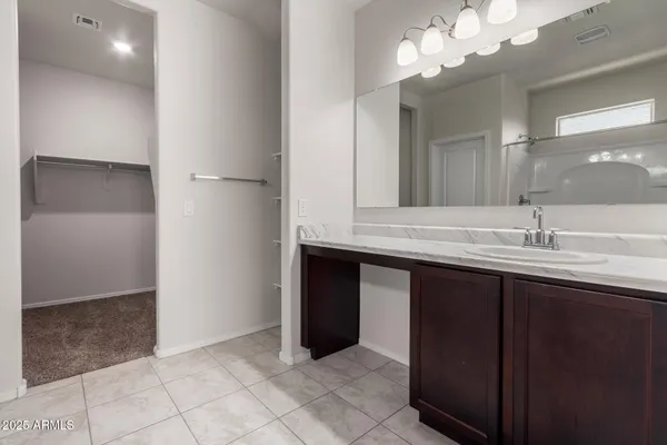 a bathroom with a sink vanity and a mirror