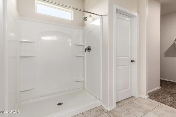 a bathroom with a glass shower door