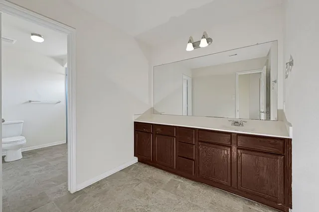 a room with a sink and a toilet