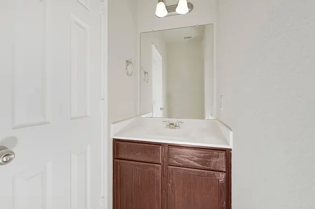 a bathroom with a sink vanity and a mirror