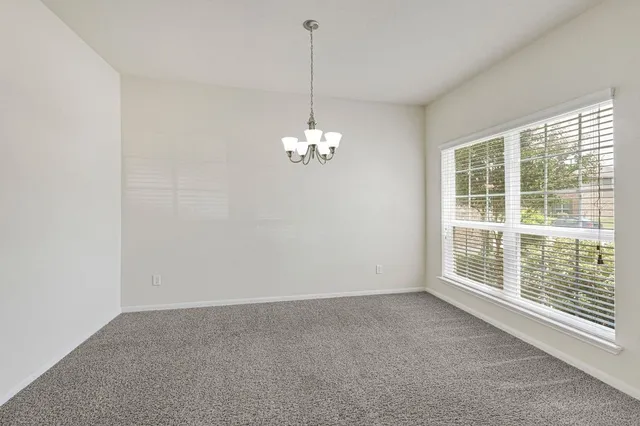 a view of a room with windows and chandelier