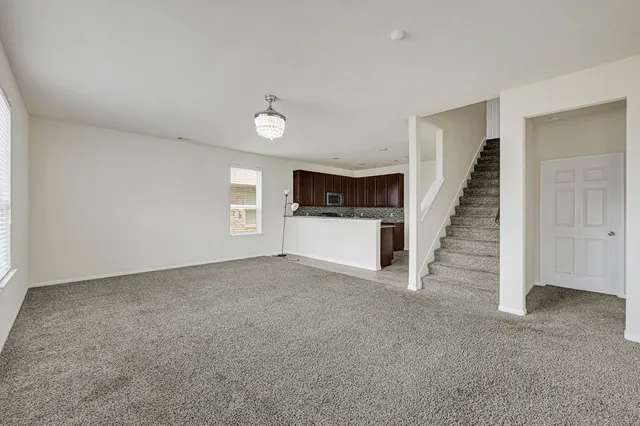 a view of an empty room with a fireplace