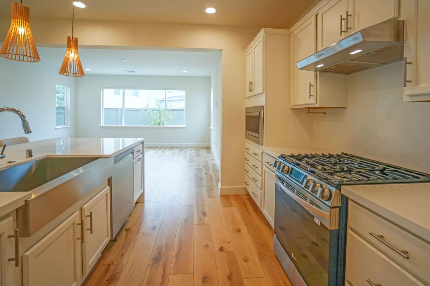 4124 Maddy Avenue Tracy, CA 95377 - Photo 14 of 55 a kitchen with sink a stove and wooden floor