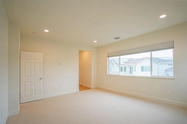 a spacious bathroom with a tub sink and mirror