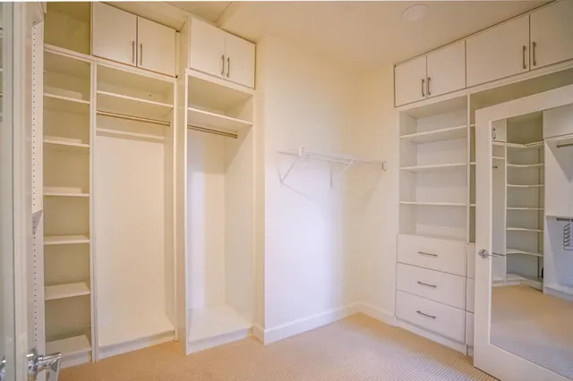 a spacious bathroom with double sink and a mirror