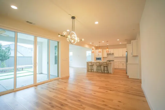 a view of a dining room with furniture wooden floor and chandelier