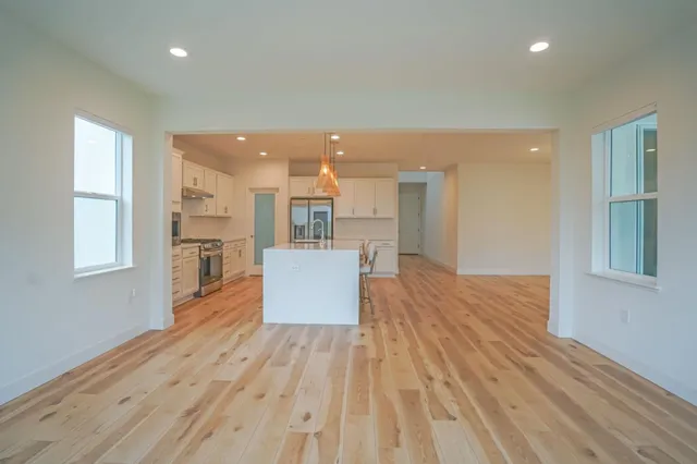 a view of a kitchen with wooden floor and a kitchen