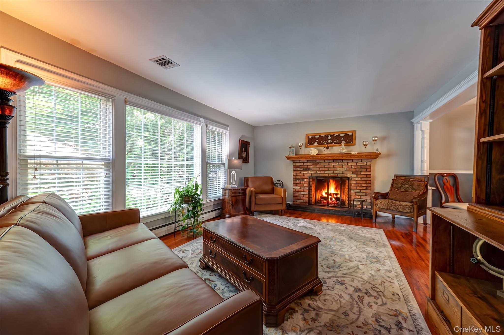3 Thompson Hill Road St. James, NY 11780 - Photo 3 of 34 a living room with furniture fireplace and large windows