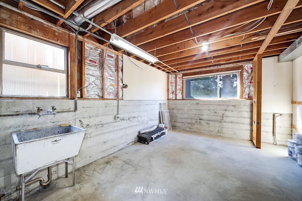 4119 Southwest Rose Street Seattle, WA 98136 - Photo 22 of 27 a bathroom with a sink and a window