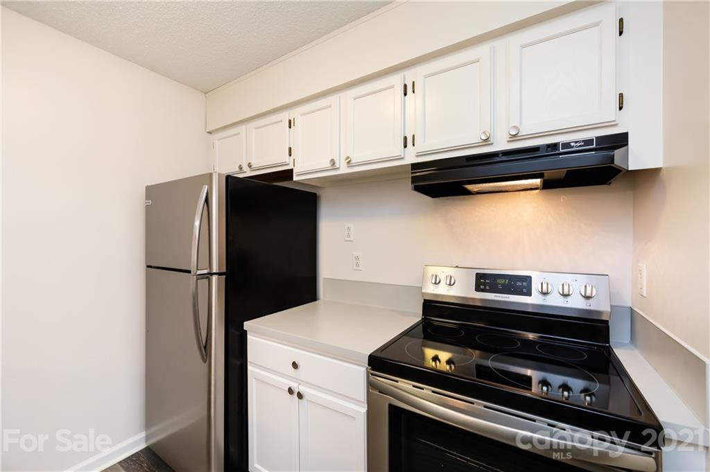 2539 Stockbridge Drive, Unit A Charlotte, NC 28210 - Photo 11 of 21 a kitchen with a stove and a refrigerator