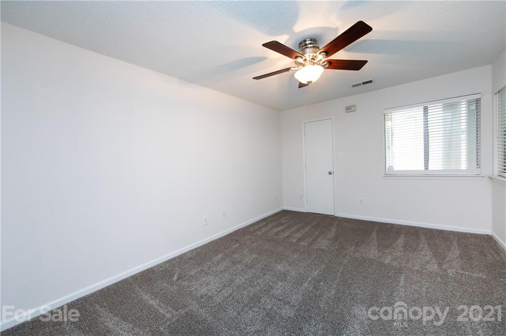 2539 Stockbridge Drive, Unit A Charlotte, NC 28210 - Photo 12 of 21 an empty room with window and ceiling fan