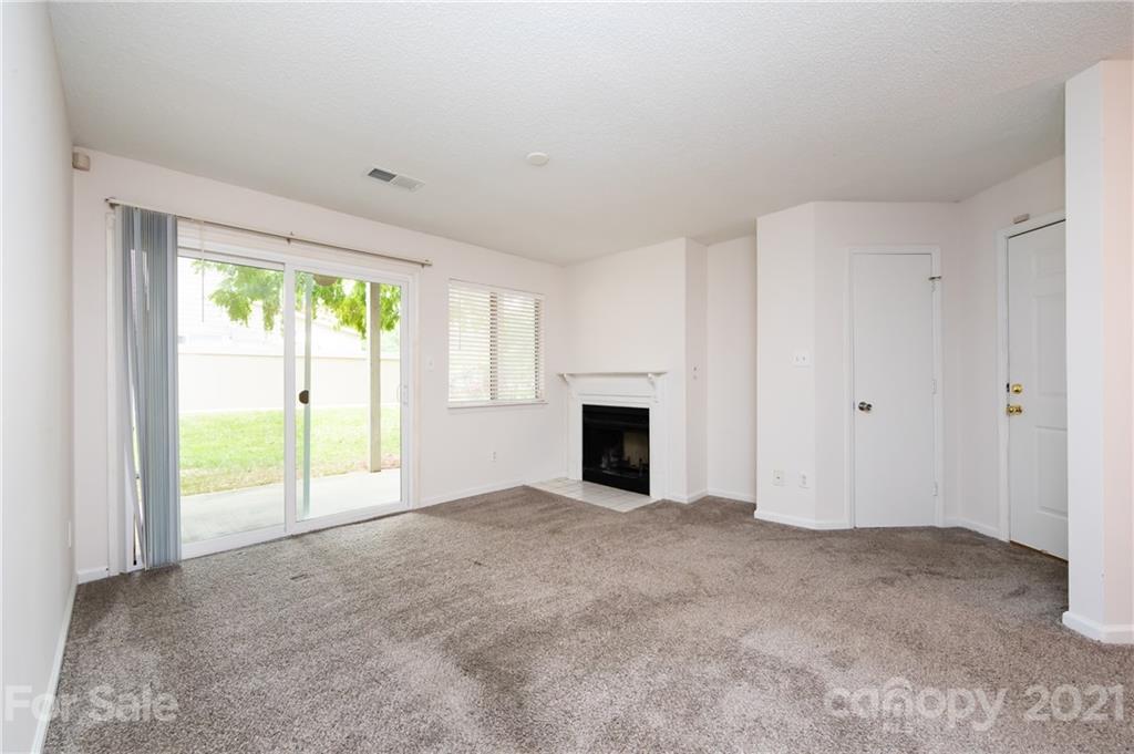 2539 Stockbridge Drive, Unit A Charlotte, NC 28210 - Photo 7 of 21 a view of an empty room with a fireplace and a window