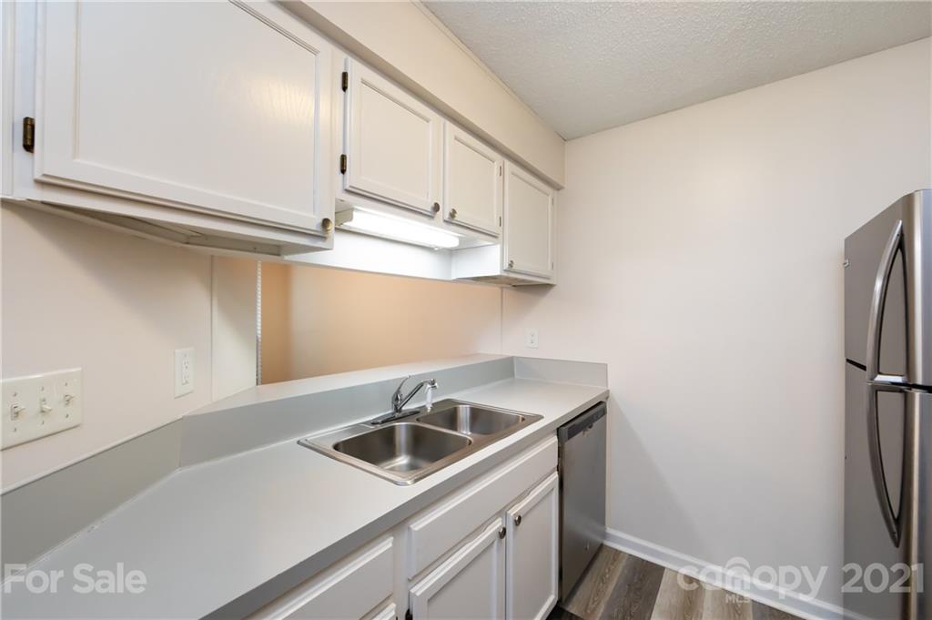 2539 Stockbridge Drive, Unit A Charlotte, NC 28210 - Photo 10 of 21 a view of a kitchen counter space a sink wooden floor and cabinets