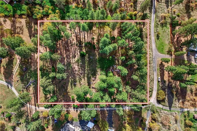 a view of a fence and trees from a window