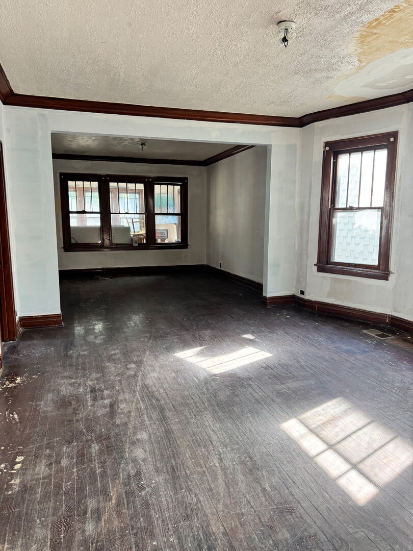 11944 South Perry Avenue Chicago, IL 60628 - Photo 5 of 8 an empty room with windows