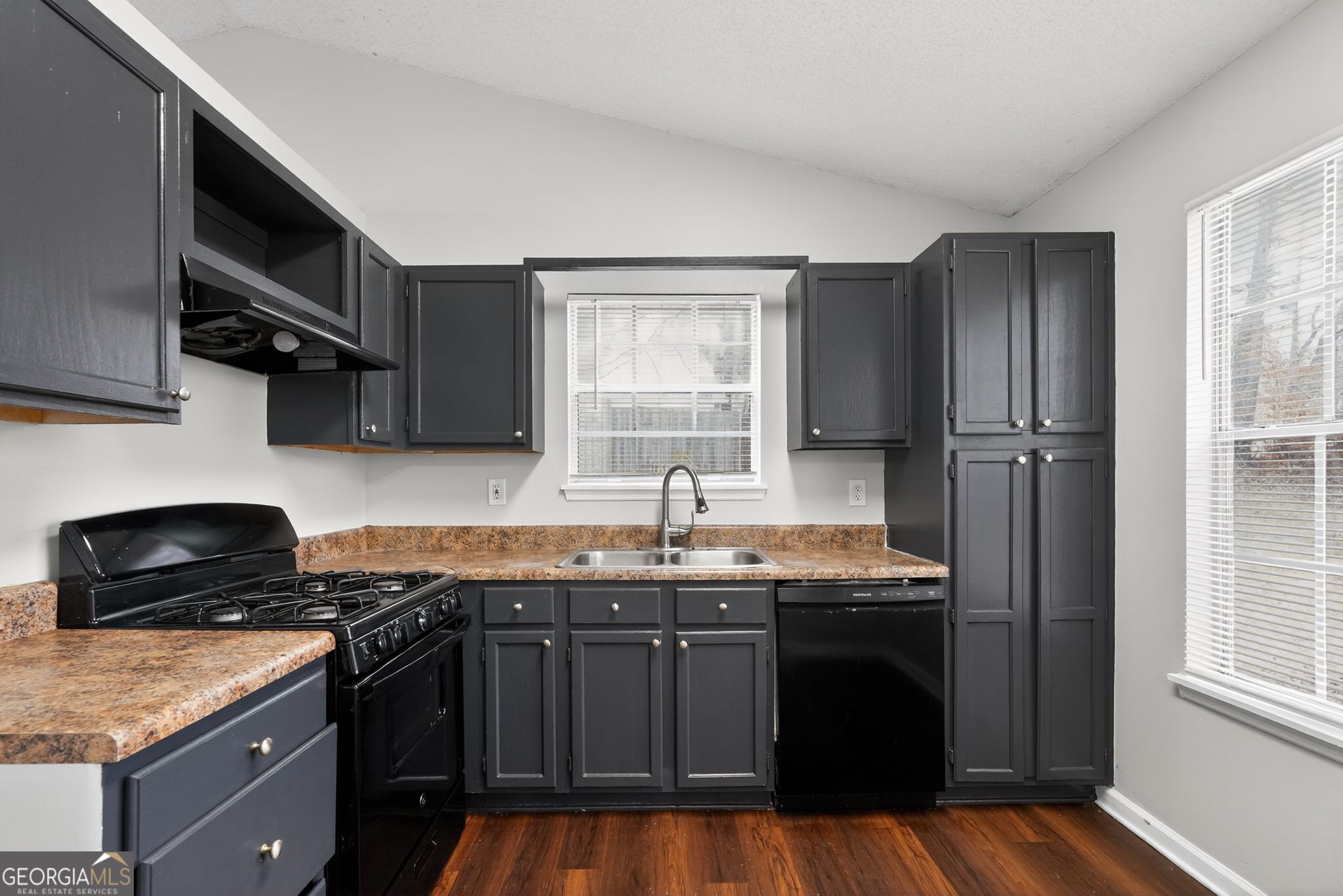 3263 River Mist Cove Decatur, GA 30034 - Photo 13 of 38 a kitchen with granite countertop a sink cabinets and stainless steel appliances