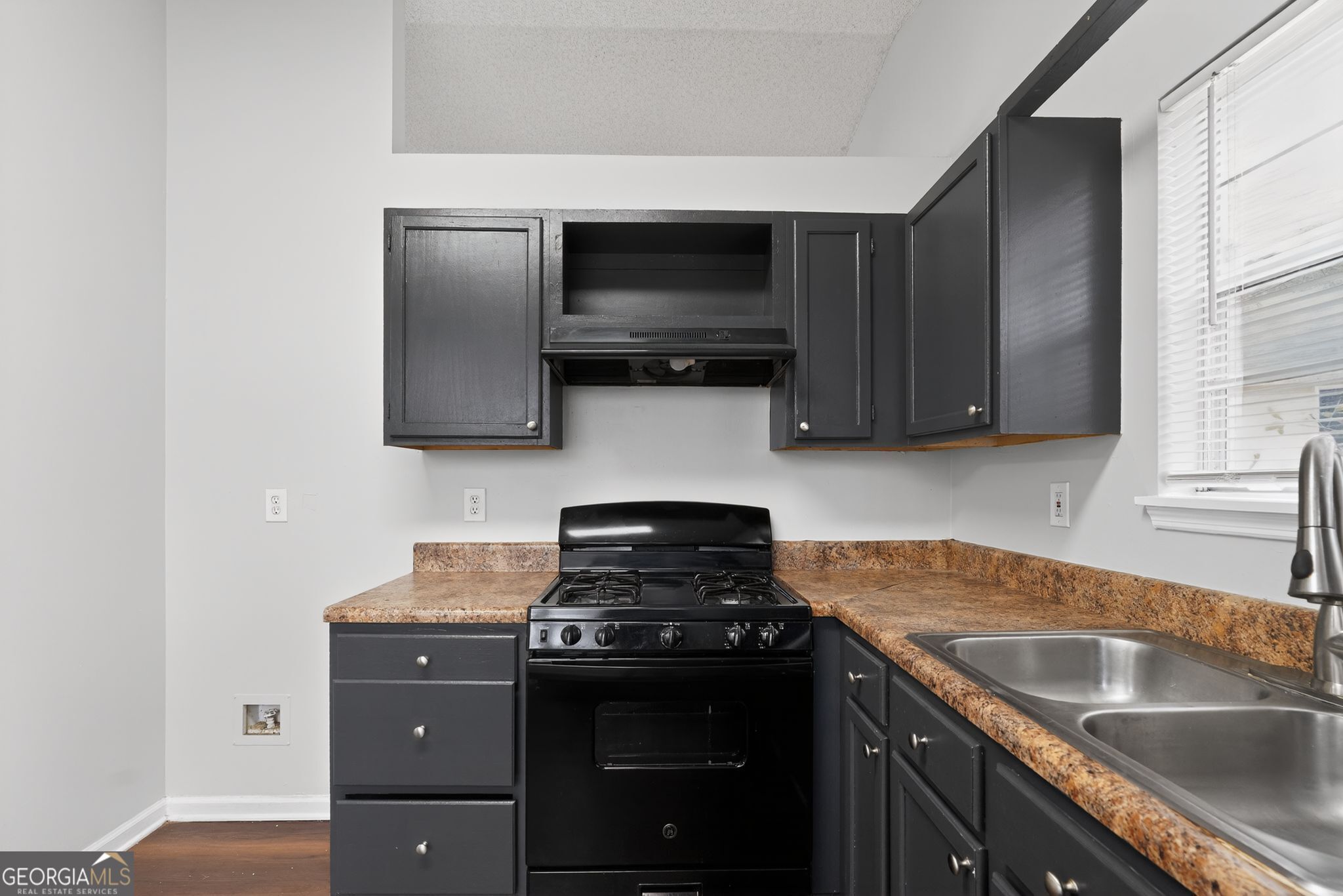 3263 River Mist Cove Decatur, GA 30034 - Photo 14 of 38 a kitchen with granite countertop a sink and a stove top oven