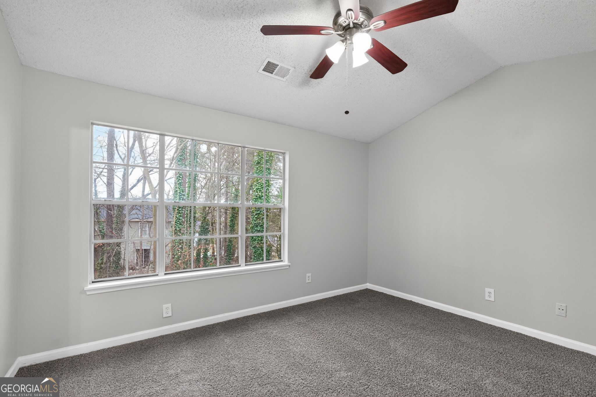 3263 River Mist Cove Decatur, GA 30034 - Photo 20 of 38 an empty room with a window and a fan