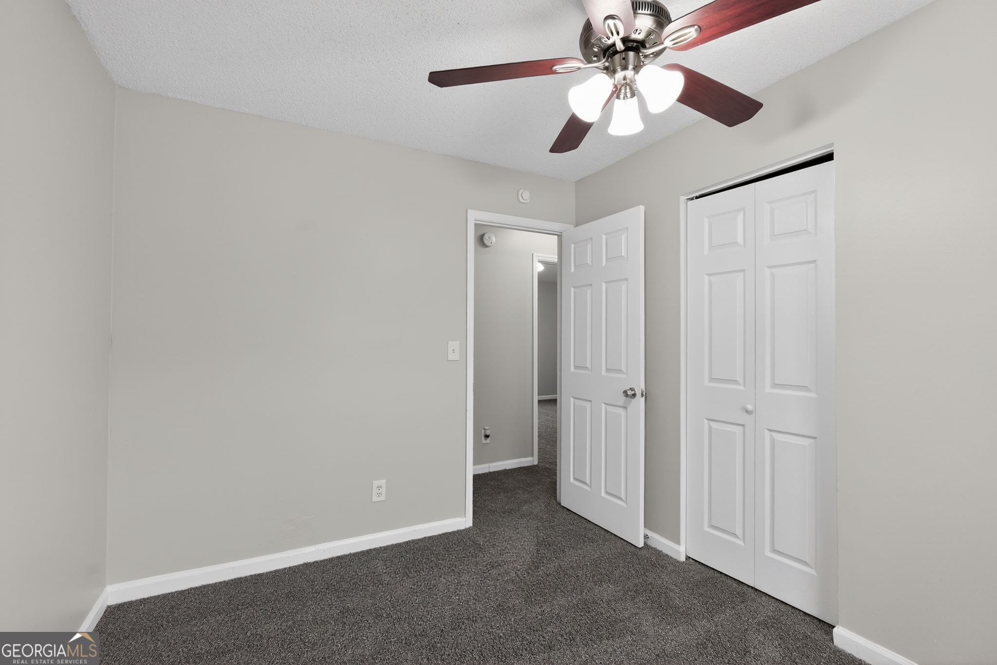 3263 River Mist Cove Decatur, GA 30034 - Photo 27 of 38 an empty room with closet and a chandelier fan