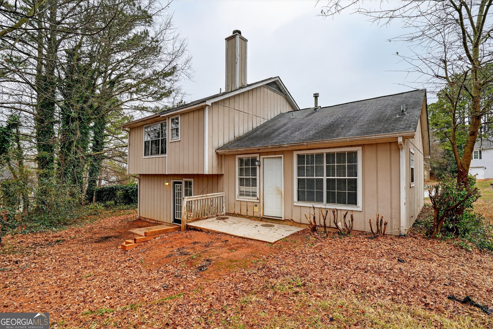 3263 River Mist Cove Decatur, GA 30034 - Photo 34 of 38 a front view of a house with a garden and yard