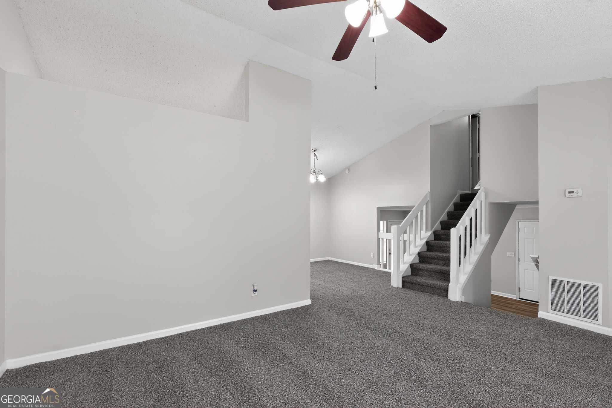 3263 River Mist Cove Decatur, GA 30034 - Photo 6 of 38 wooden floor in an empty room with a ceiling fan