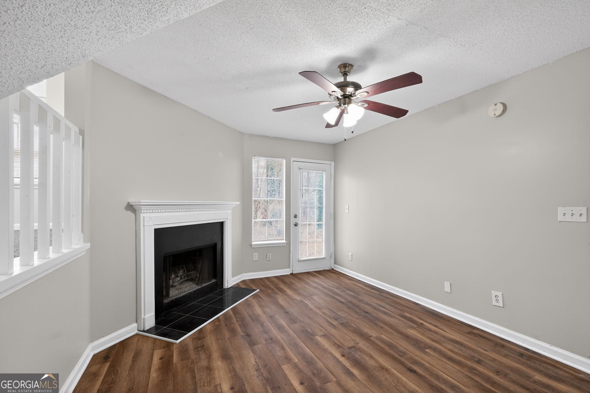 3263 River Mist Cove Decatur, GA 30034 - Photo 8 of 38 a view of an empty room with window and wooden floor