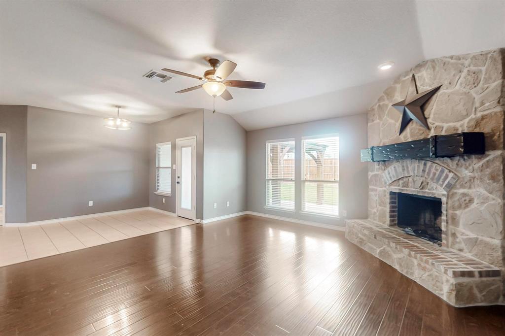 970 Austin Lane Lavon, TX 75166 - Photo 14 of 26 a view of an empty room with wooden floor and a fireplace
