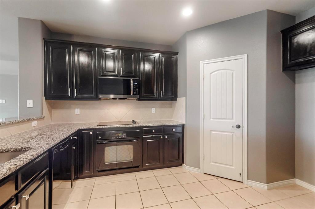 970 Austin Lane Lavon, TX 75166 - Photo 17 of 26 a kitchen with stainless steel appliances granite countertop a stove and a sink