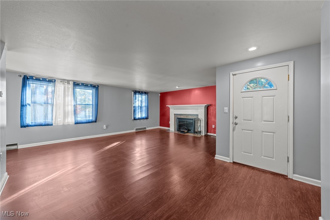 5865 Ruple Parkway Brook Park, OH 44142 - Photo 44 of 45 Unfurnished living room featuring hardwood / wood-style floors and a textured ceiling