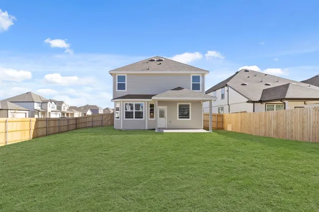 a aerial view of a house next to a big yard and large trees