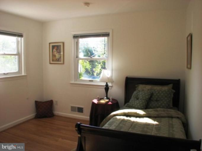 3713 North Glebe Road Arlington, VA 22207 - Photo 24 of 30 a bed sitting in a bedroom next to a window