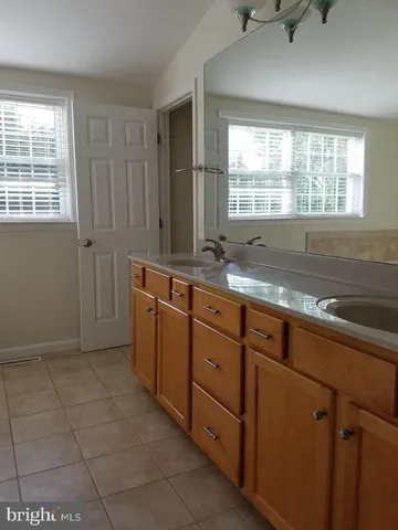 a kitchen with granite countertop a sink cabinets and window