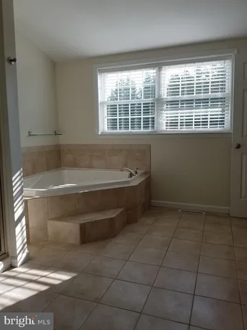 a bathroom with a bathtub and window