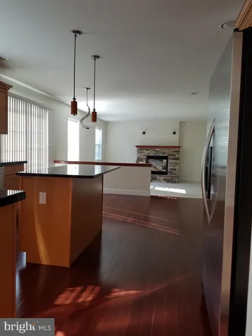 a kitchen with stainless steel appliances granite countertop a refrigerator a stove and a sink