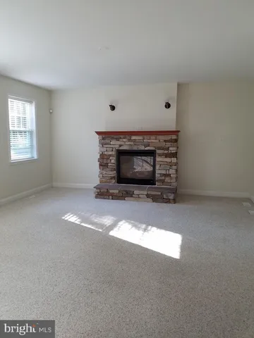 a view of empty room with a fireplace