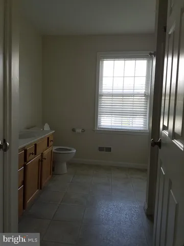a bathroom with a toilet sink and window